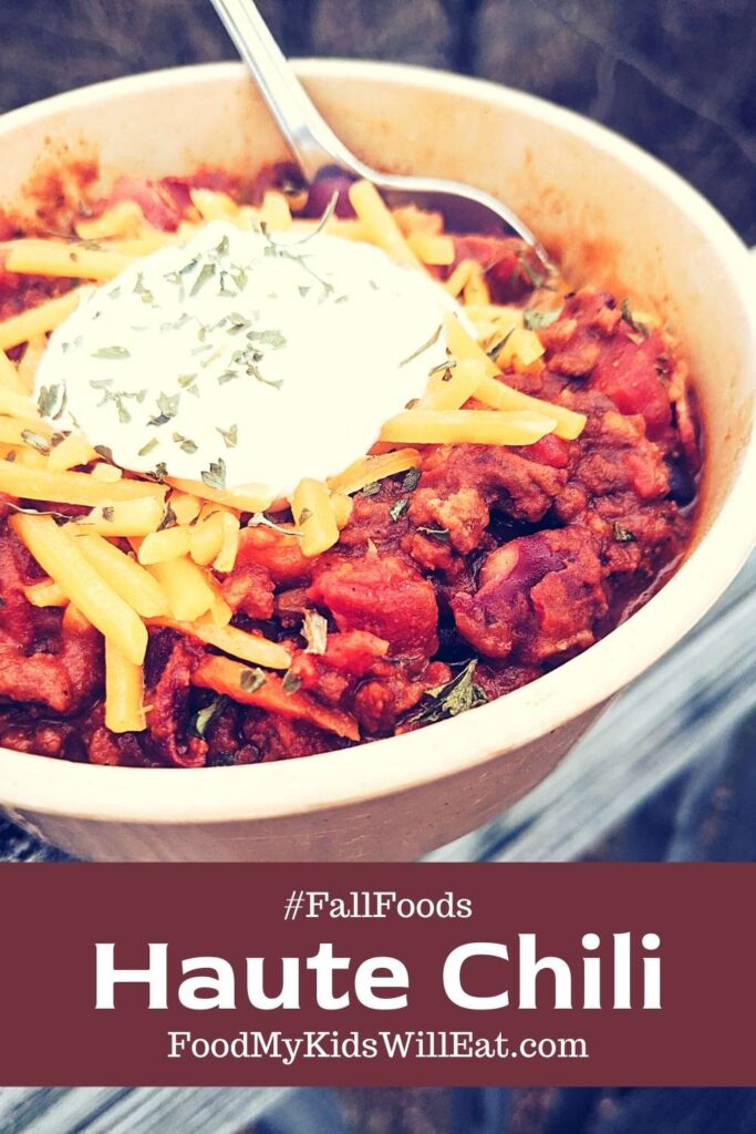 Haute Chili. Yummm. 5 Photo of chili topped with cheddar cheese and sour cream overlooking fall vibes.