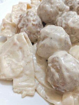 Swedish Meatballs with thick Amish egg noodles, homestyle meatballs, and a creamy sauce.