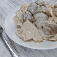 Swedish Meatballs with thick Amish egg noodles, homestyle meatballs, and a creamy sauce.