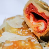 Pizza Egg Rolls featuring pepperoni, cheese, and parmesan cheese
